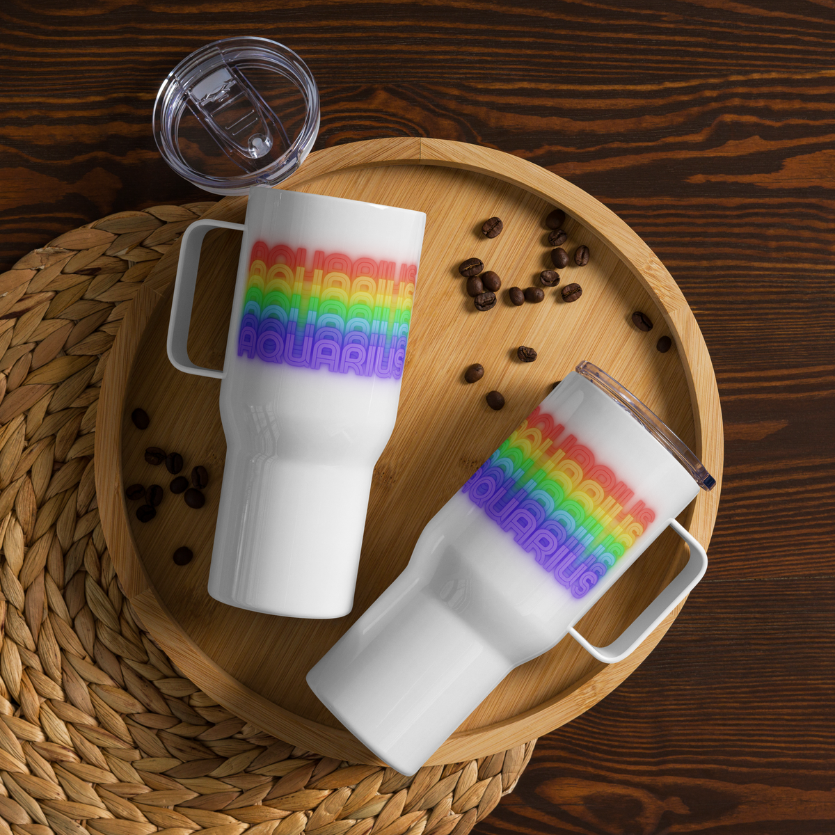 Two 25 oz. white mugs with Aquarius rainbow text on a wooden tray with coffee beans.