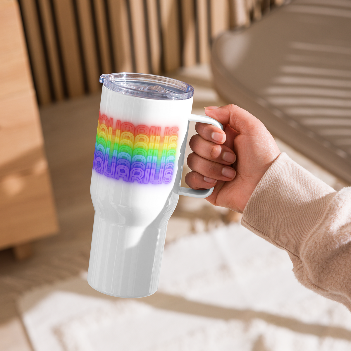 Aquarius Rainbow White Travel-Mug-with-Handle-25-oz-Held by a Left-hand person indoors