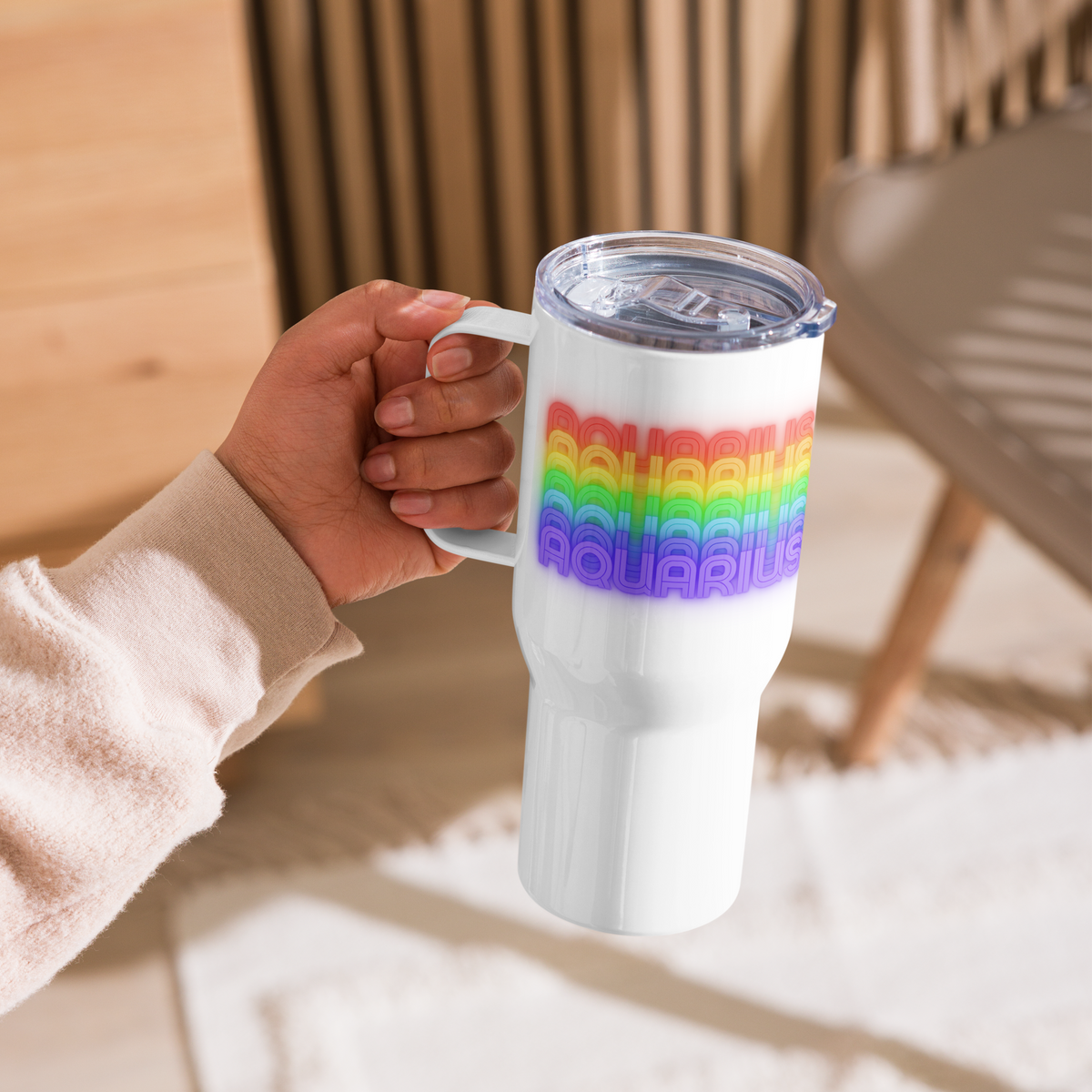 Aquarius Rainbow White Travel-Mug-with-Handle-25-oz-Held by a right hand in a casual setting