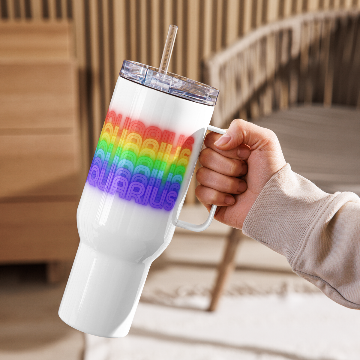 Aquarius Rainbow White Travel-Mug-with-Handle-40-oz. held by a left-hand outdoors