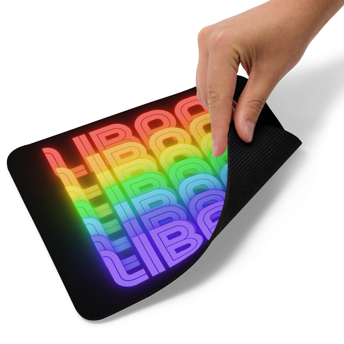 A black mouse pad with rainbow colored Libra text pattern being used by a person with a hand.